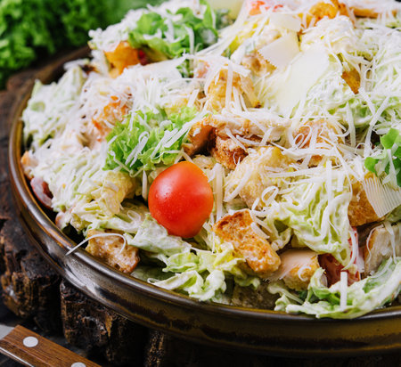 Fresh Caesar Salad on a Wooden Kitchen Tableの写真素材