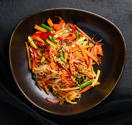 Asian vegetarian udon noodles with vegetables in a bowlの写真素材