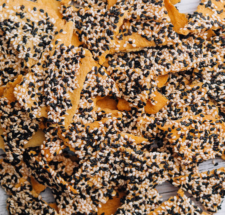 Salted tortilla chips triangle with chia seeds on top view
