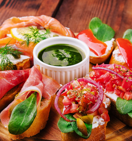 Different bruschetta on a wooden boardの写真素材