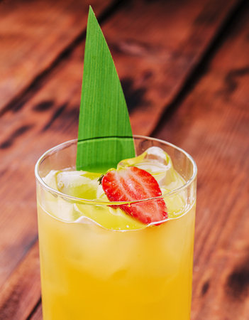 mai tai cocktail with pineapple and rum with a piece of strawberryの写真素材