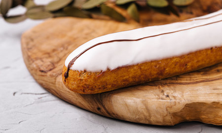 Glazed eclair dessert on wood closeupの写真素材