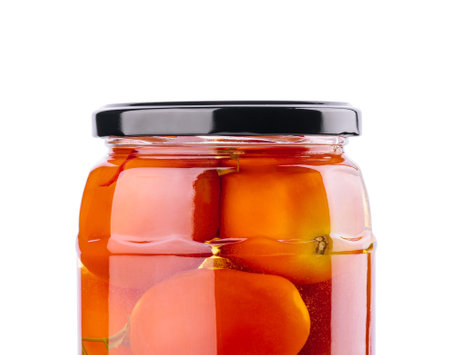 Pickled tomatoes in glass jar on white backgroundの写真素材
