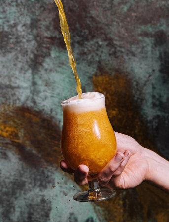 pouring fresh beer into glassの写真素材