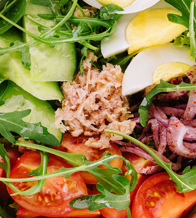 tuna fish salad with eggs, cucumber, tomatoes and arugulaの写真素材