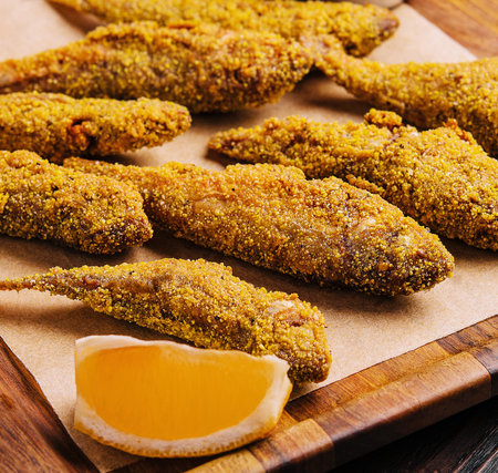 Fried smelt on a wooden chopping boardの写真素材