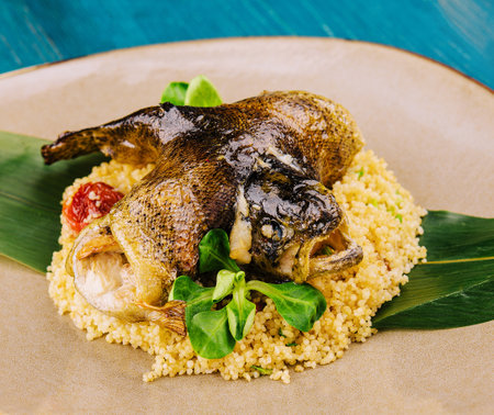 couscous with fish on brown plateの写真素材