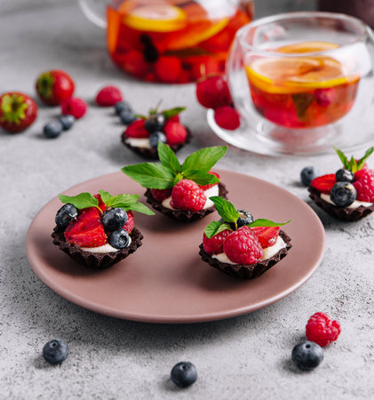 Chocolate ganache tarts with fresh berriesの写真素材