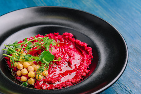 horseradish with chickpeas in a black plateの写真素材