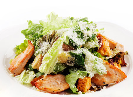 Traditional classic Caesar salad in white plateの写真素材