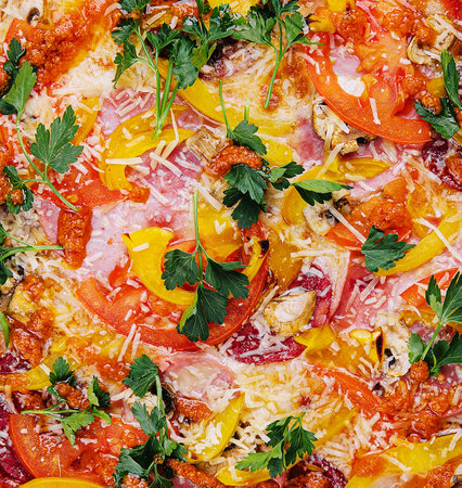 Fresh delicious pizza made in a hearth oven with sausage, pepper and tomatoesの写真素材