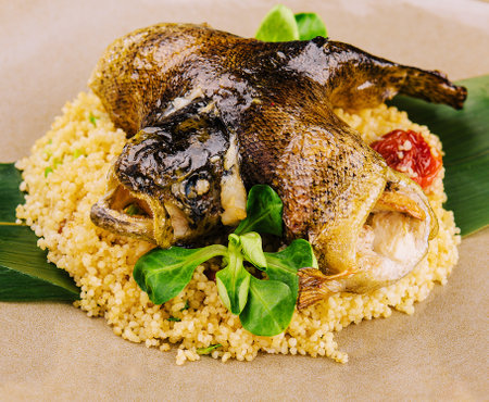 couscous with fish on brown plateの写真素材
