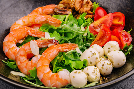 Salad with fresh arugula leaves, mozzarella cheese and shrimpsの写真素材