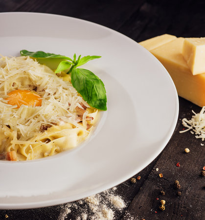 Carbonara pasta with raw egg, bacon and parmesan cheeseの写真素材