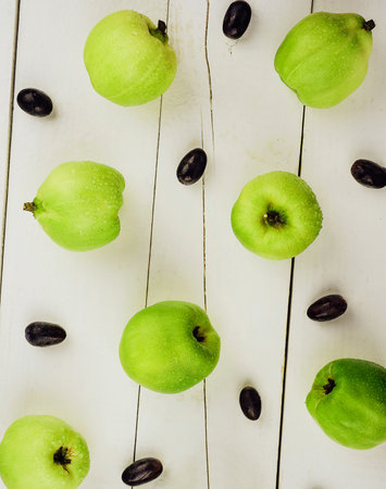 Ripe green quince fruits on wood
