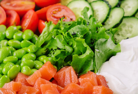Poke bowl with salmon, cucumber, tomato, rice and edamame beans