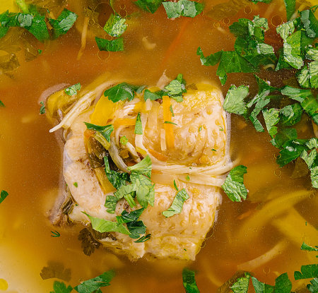 Chicken soup with noodles and vegetables in bowlの写真素材