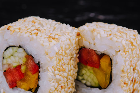 vegan sushi rolls with sesame seeds, peppers and cucumbersの写真素材