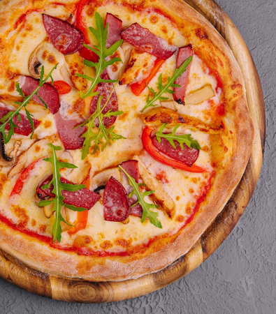 Fresh delicious pizza with three types of meat and sausageの写真素材