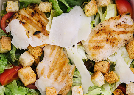 Caesar salad packed on craft box for take awayの写真素材