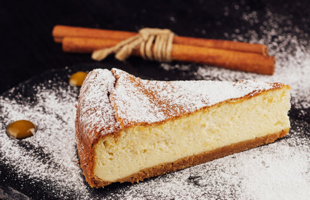 Delicious cheesecake with vanilla on black boardの写真素材