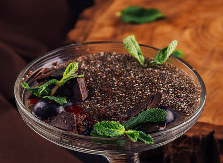 Chocolate mousse dessert with prunes and mint leaves in portion glassesの写真素材