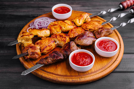 Metal skewers with delicious meat and ketchup sauceの写真素材