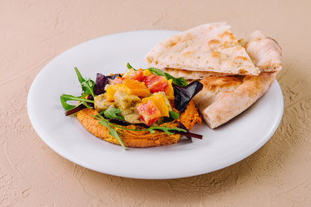 Healthy roasted red pepper hummus and pita breadの写真素材