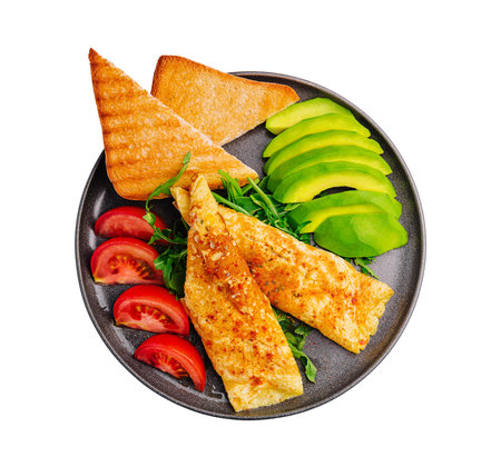 Omelette with avocado, tomatoes and arugula on black ceramic plateの写真素材