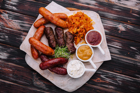 Beer set of grilled sausages with stewed cabbage and saucesの写真素材
