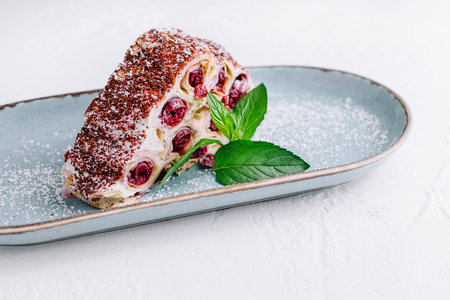 Triangle cherry cake with cream and chocolate sprinkles