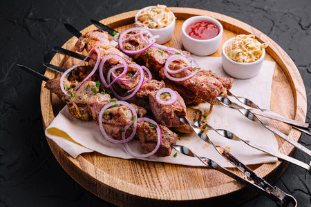 kebabs from pork on skewers on wooden boardの写真素材
