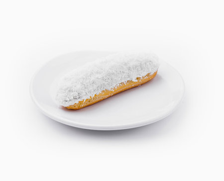 eclair in white glaze and coconut flakesの写真素材