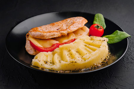 Baked chicken fillet with cheese and mashed potatoesの写真素材