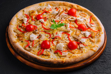 Pizza with chicken and tomatoesの写真素材