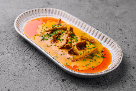 lasagna with chanterelle mushrooms in yellow sauceの写真素材