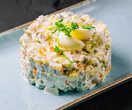 Salad Olivier on blue plateの写真素材