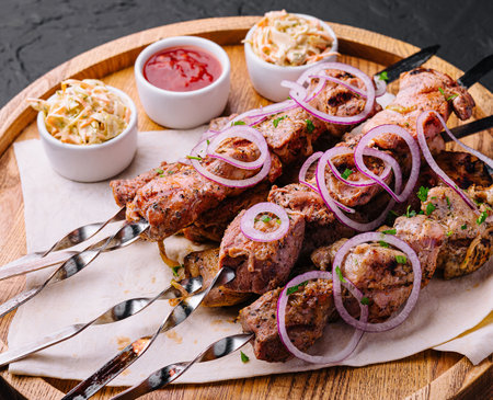 kebabs from pork on skewers on wooden boardの写真素材