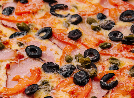 Pizza with ham, parmesan cheese and olivesの写真素材