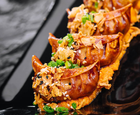 Fried dumplings Gyoza on black plateの写真素材