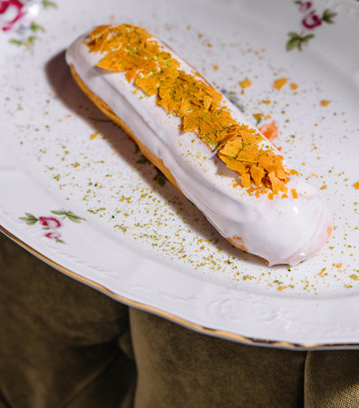 Close up of eclair with white cream and chips