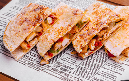 Mexican quesadilla with chicken on wooden boardの写真素材