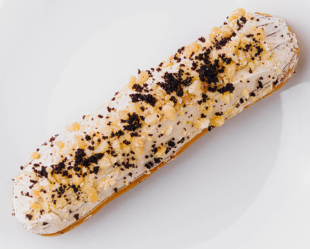 Eclair with cream and chocolate on plate