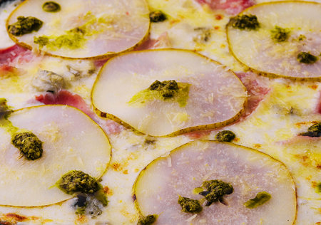 close up pizza with pear, cheese and hamの写真素材