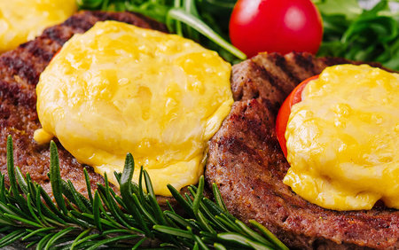 Meatballs or cutlets with tomato and cheeseの写真素材