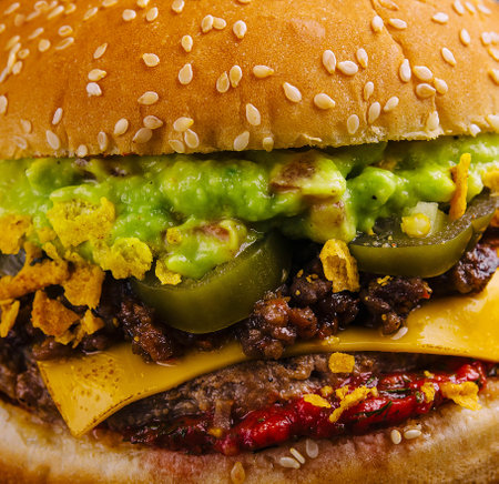 veggie burger with guacamole and pickles on toasted bunの写真素材