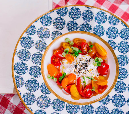 Caprese salad with tomatoes, mozzarella, basil, pestoの写真素材