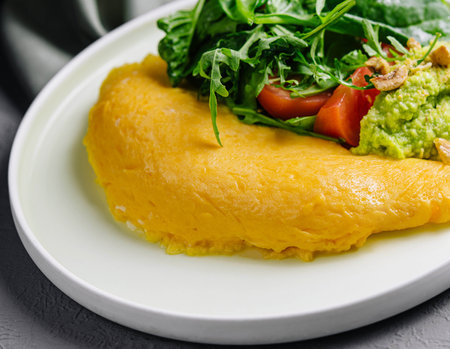 Omelette Served with Avocado puree and Cherry Tomatoesの写真素材