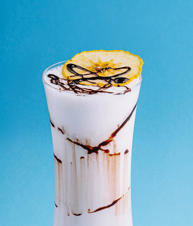 glass cup of milkshake with dry pineappleの写真素材