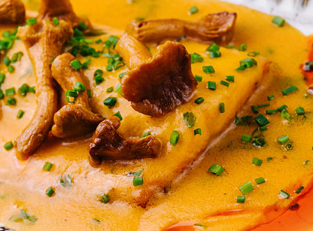 lasagna with chanterelle mushrooms in yellow sauce